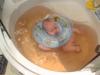 Lapsen kylpeminen aikuisen kylpyammeessa Vastasyntyneen uiminen suuressa kylpyammeessa